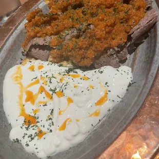 a plate of food with mashed potatoes and meat