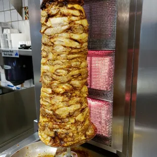 a large meat skewer being cooked