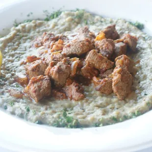 a plate of food with meat and gravy
