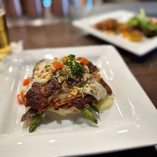 Barramundi (Asian Sea Bass), with lemon butter sauce and lump crab. Served over mashed potatoes and asparagus.   Was so dang good