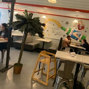 the interior of a restaurant with tables and chairs