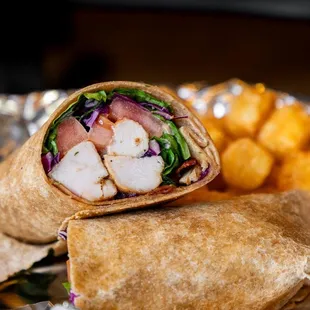 a chicken wrap and fries on a plate