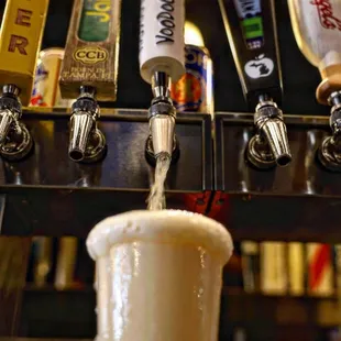 a beer being poured into a mug