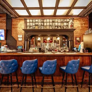 a bar with blue leather chairs