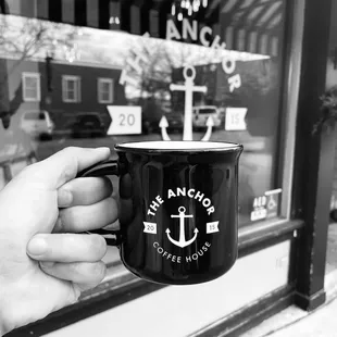 a hand holding a coffee cup