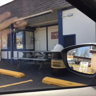 the reflection of a person's hand in a rear view mirror