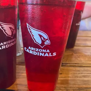 a closeup of two red cups with the logo of the arizona cardinals
