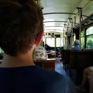 The inside of the trolley and the back of Tommy's head.