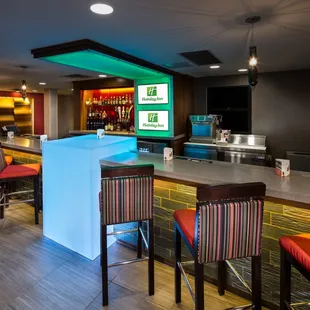 a bar with colorful bar stools