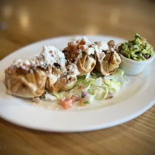 Blackened shrimp taquitos with fresh guacamole.