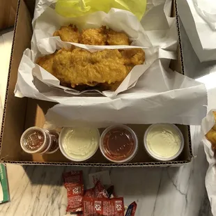 Fish, scallops and chips (fries are under the fish)...dipping sauces are always added in the box