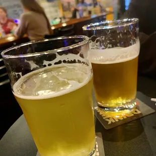two glasses of beer on a table