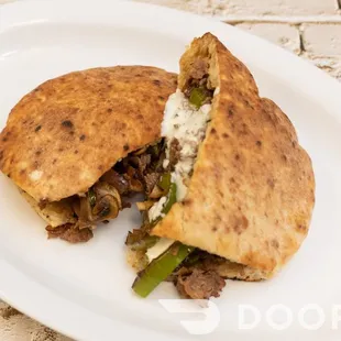 a pita sandwich on a white plate
