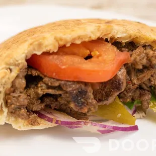 a pita sandwich on a white plate