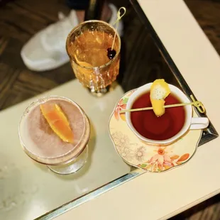 two cups of tea and an orange slice