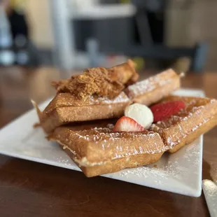 a plate of waffles and strawberries