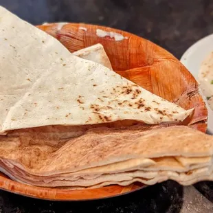 a plate of pita and a bowl of hummus