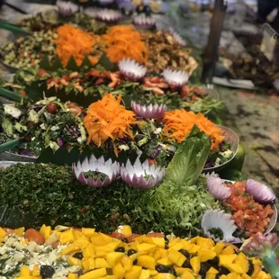 Salad bar , tabouli , pasta , Fatoush , Greek , falafel salad , kale and much more