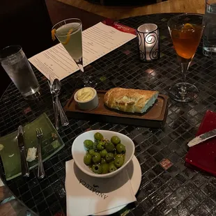 Olives, bread with sea salt, and cocktails