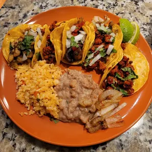 Taco Plate. From left to right: chorizo, chicharron, fajita, and two al pastor