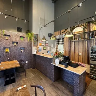 a dining area with a bar and a wine fridge