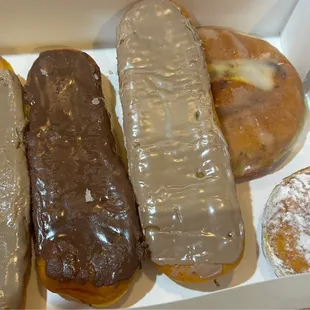 Longjohns, raspberry cream filled donut &amp; cinnamon roll beneath the maple longjohn.