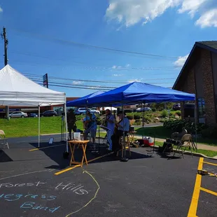  group of people standing under tents