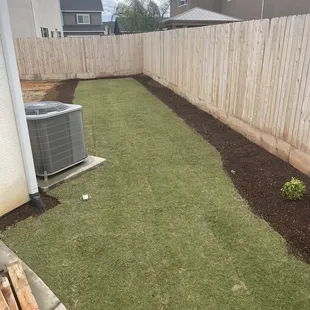 a back yard with an air conditioner
