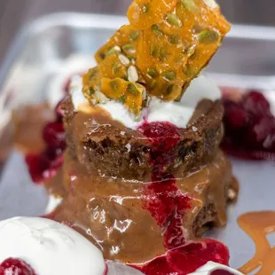 a piece of cake with whipped cream and cherries