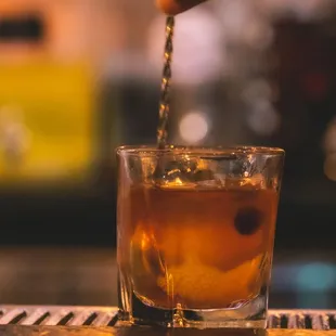 a person pouring a drink