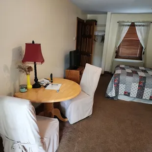 Table and chairs, with bed.