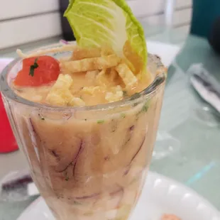 an ice cream sundae with a garnish of lettuce and tomatoes