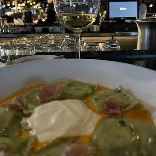 Seasonal Ravioli (Ricotta Filled Spinach Pasta with Prosciutto on top).