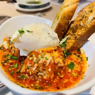 a bowl of soup with bread