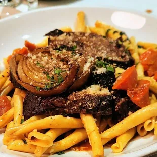 a plate of pasta with meat and vegetables