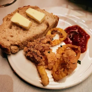 a piece of bread with butter and onion rings