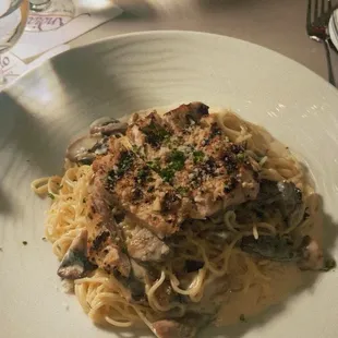 Angel hair pasta with Alfredo sauce, chicken, and mushrooms.