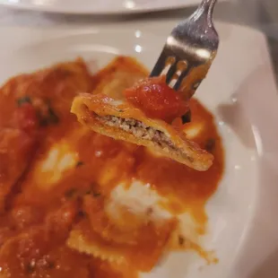 a fork holding a piece of ravioli