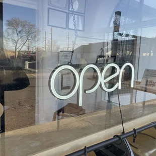 the open sign in the window
