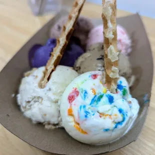 Sampler Flight. $7.75. Baklava, Cake Batter, Oreo Latte, Ube, Malted Twix, Rose Pistachio. Topped with 2 waffle wedges.