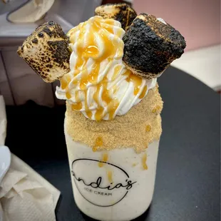 Torched S&apos;more vanilla milk shake with caramel dripped on top.