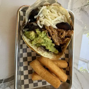 Arepa Pabellon (shredded beef, avocado, cheese) with a side of fries.