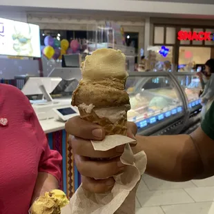 Three ice cream scoops in a cone
