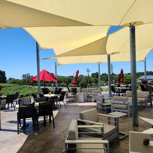 a patio with tables and umbrellas