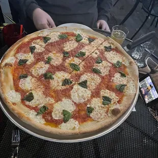 a man holding a pizza