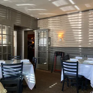 a dining room with tables and chairs