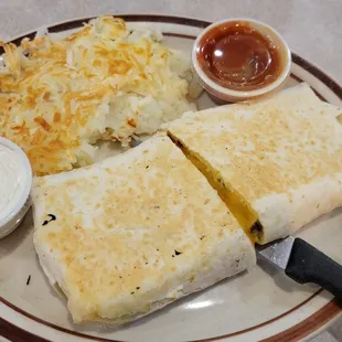 Sausage, bacon, and cheese burrito with hash browns
