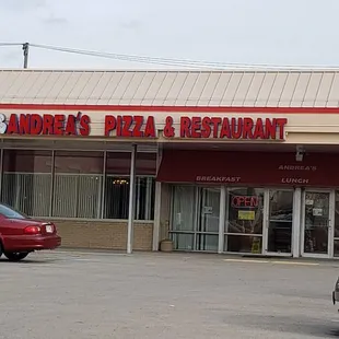 two cars parked in front of a restaurant
