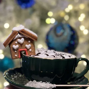 Andreas Truffle Cocoa with Baileys, Kahlua, Espresso, Homemade Whipped Cream, Chocolate Drizzle, and Mini Gingerbread House