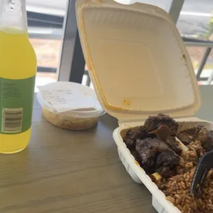 Jerked White Meat Chicken, Oxtail, Cabbage, and Rice and Beans. Oh don&apos;t forget the pineapple drink